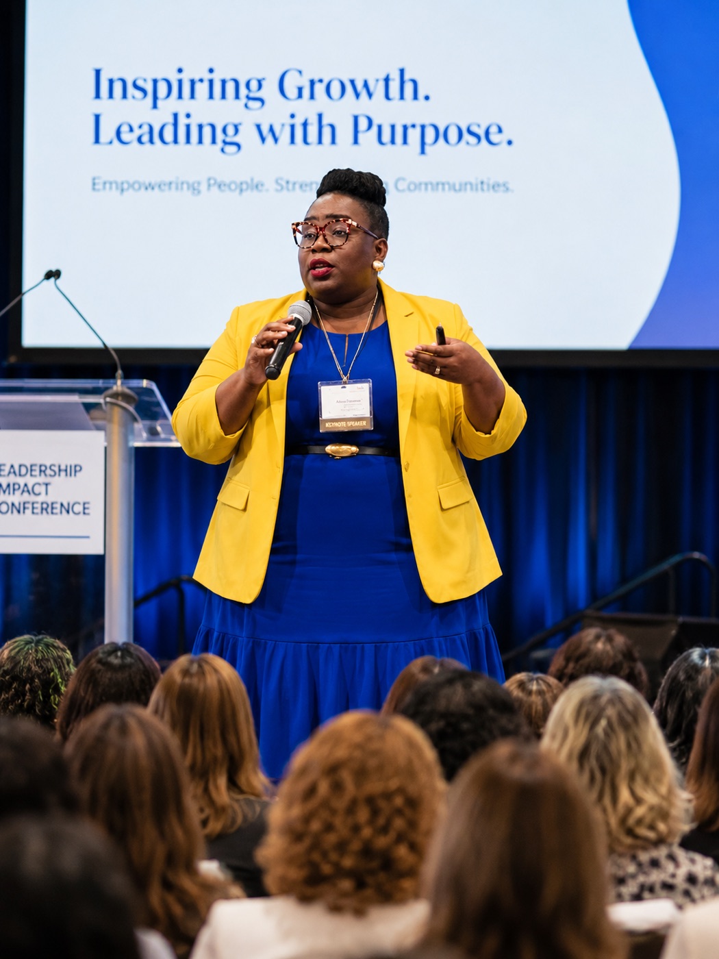 Dr. Takiwi delivering a keynote at a leadership conference